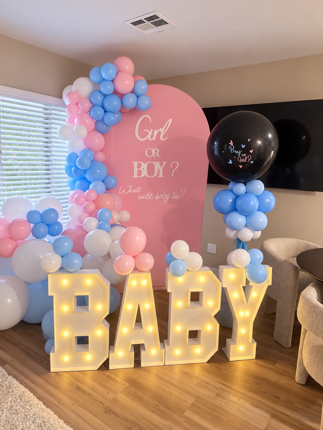 Gender reveal balloon décor and marquee letters by Moments by AMMI & Company LLC