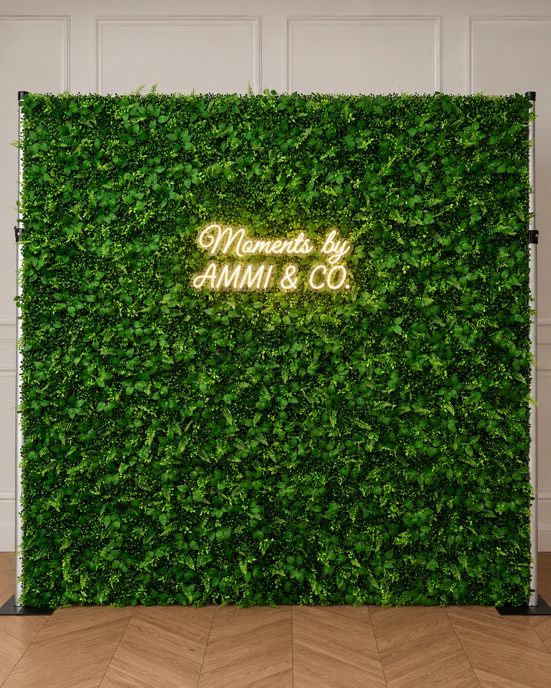 Greenery wall with Good Vibes Only pink neon sign